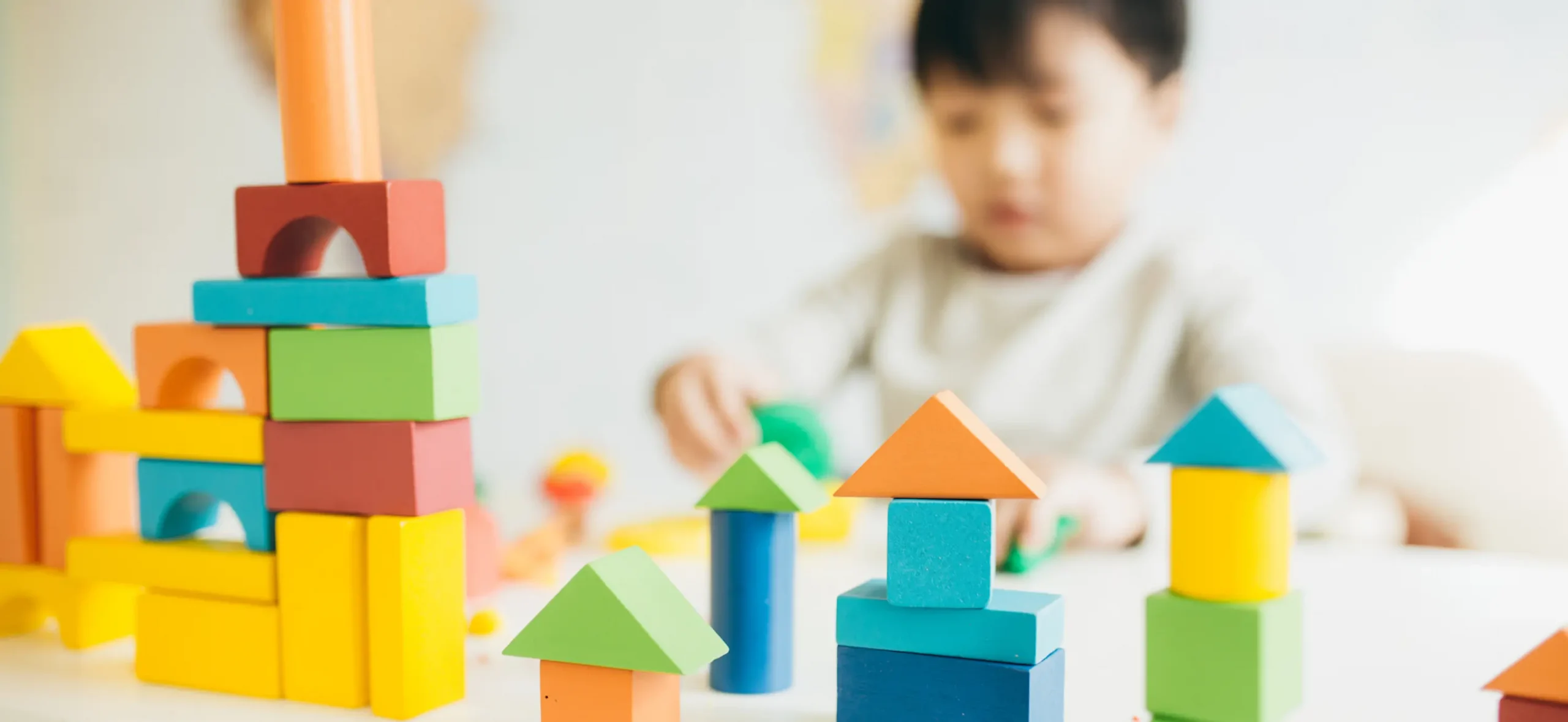 Autistic child playing with colourful building blocks