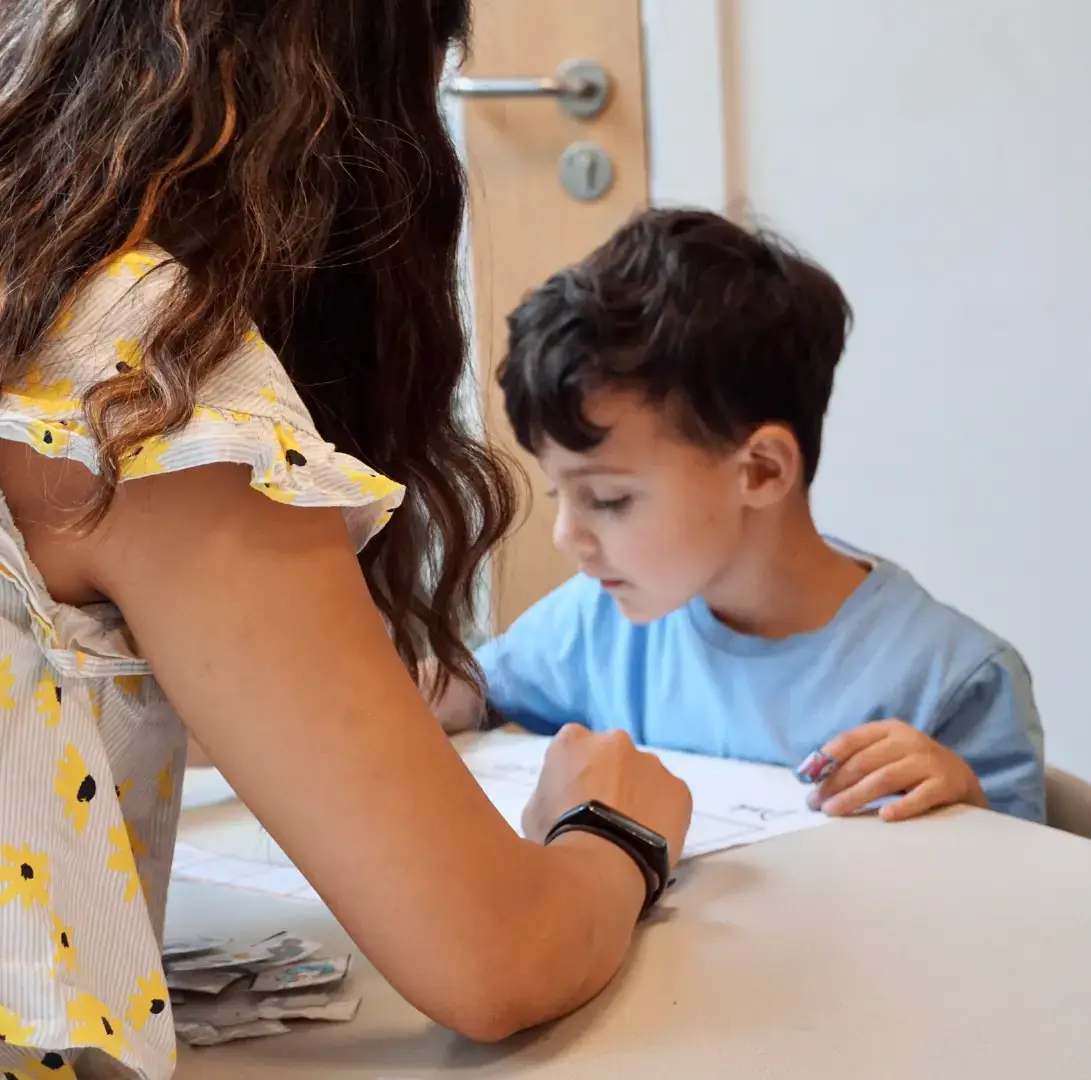Autistic child learning at school with his therapist and teacher