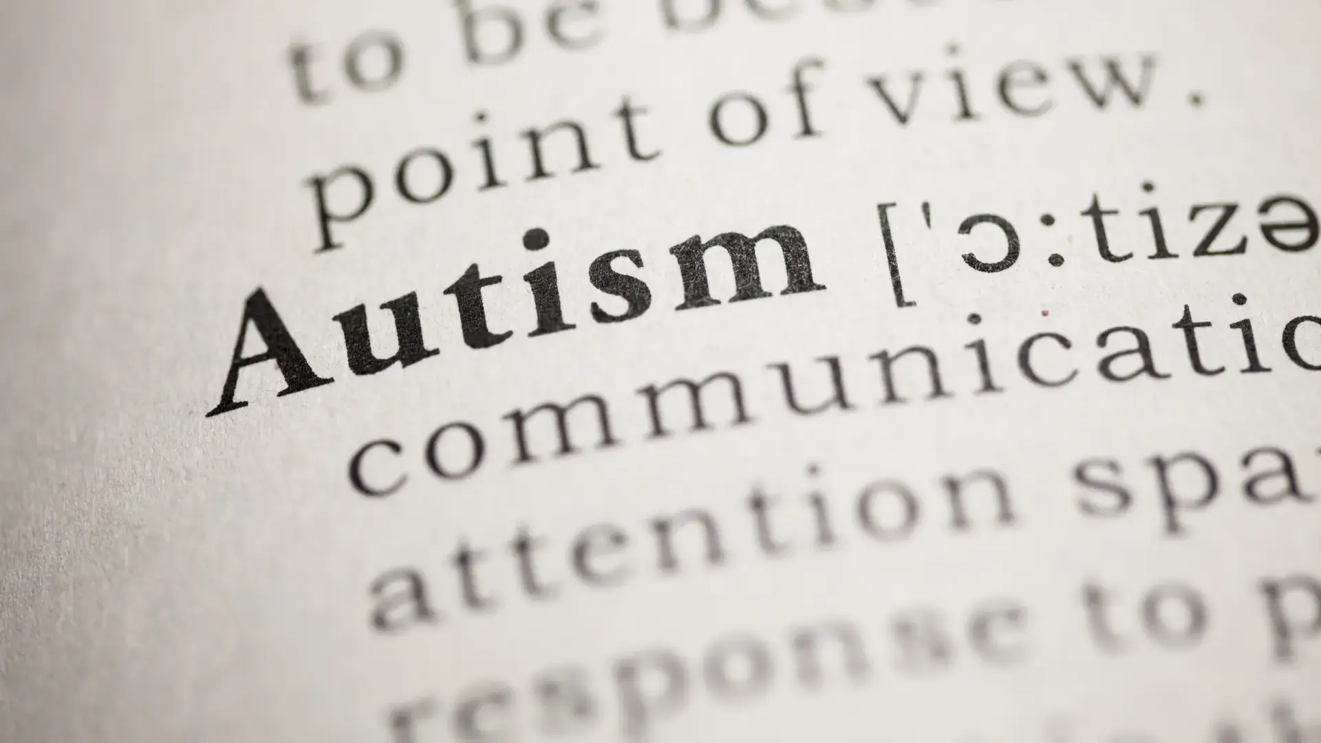 Focus on a dictionary page with the word Autism in bold