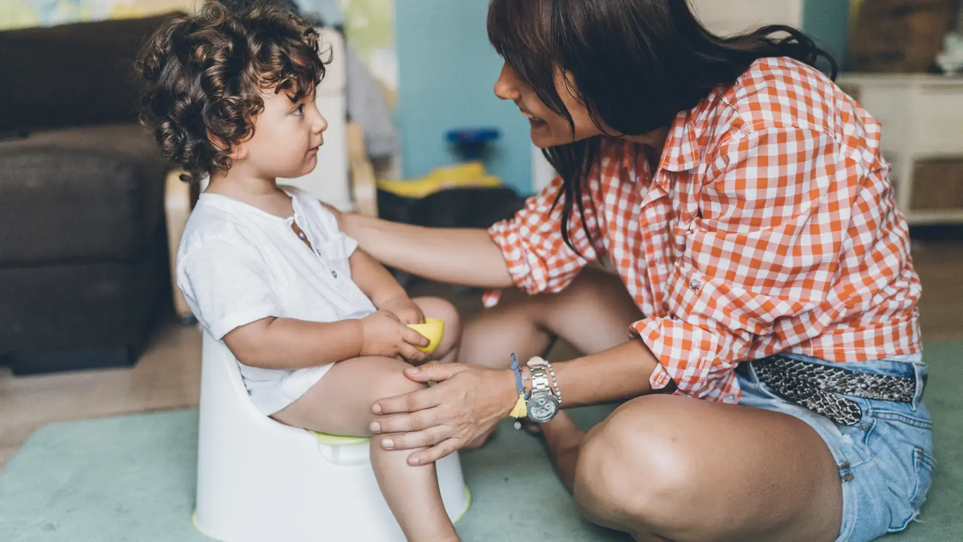 A mother helping her child with potty training