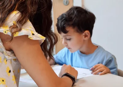 An autistic little boy learning at school with his therapist