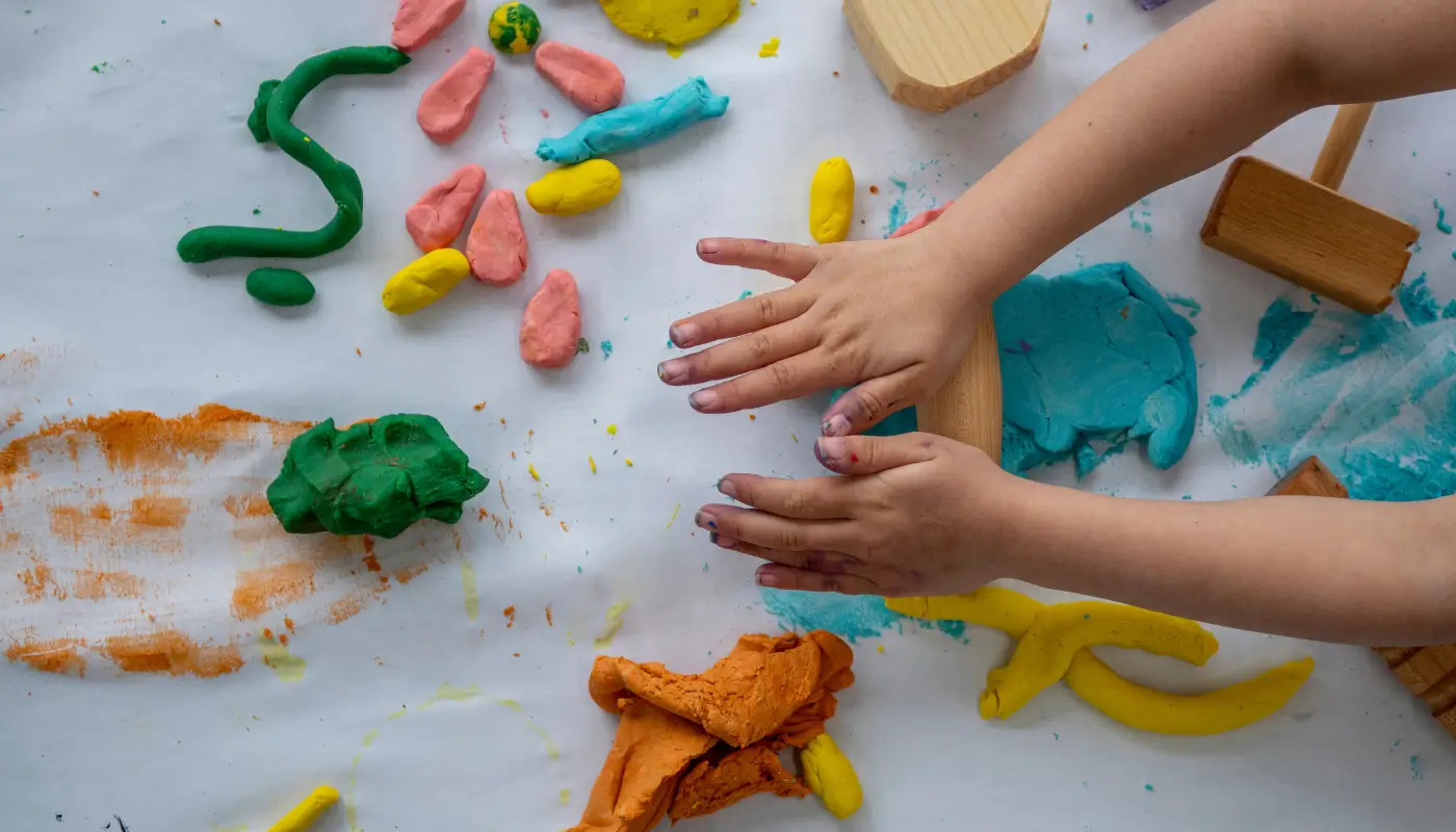 Picture of a child's hands playing with playdough