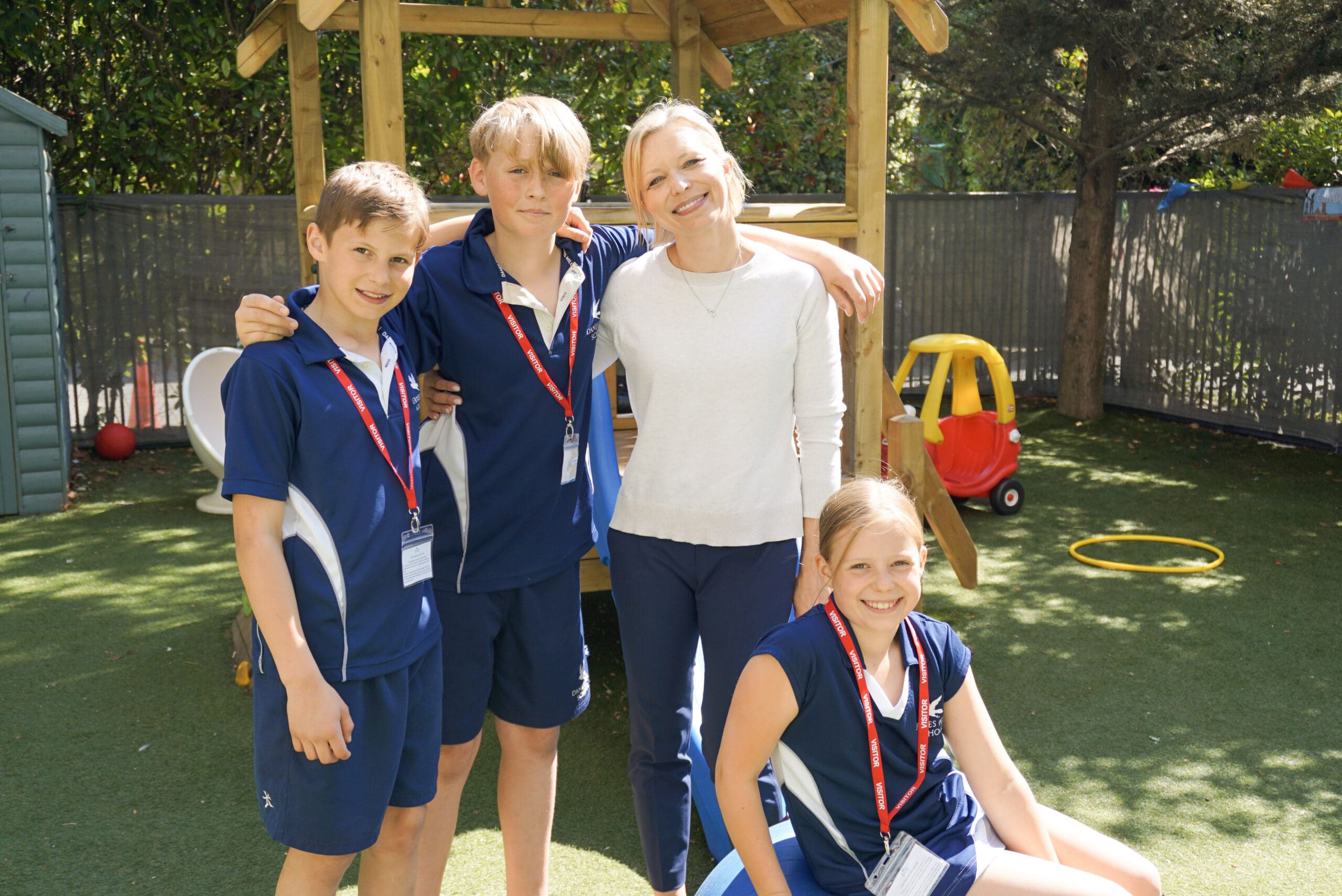 First Bridge Education Founder and CEO Sasha stands smiling with her children Jake and Bailey and their friend Oscar from Danes Hill School during an inclusive garden play session. The children volunteered their time to support outdoor learning activities, promoting peer interaction, community engagement, and inclusive early intervention.